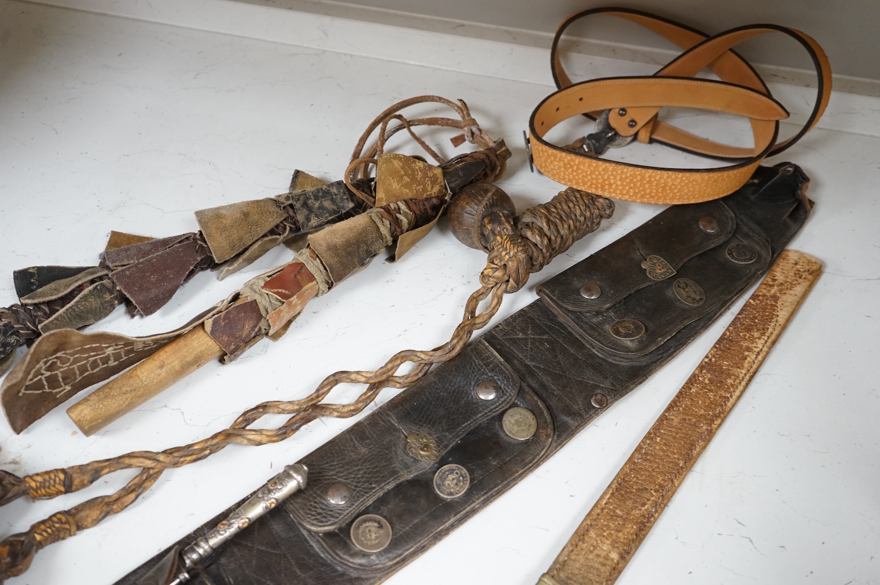 A group of Argentinian Gaucho spurs, bolas, bull whip, daggers and hanger, Longest 100cm